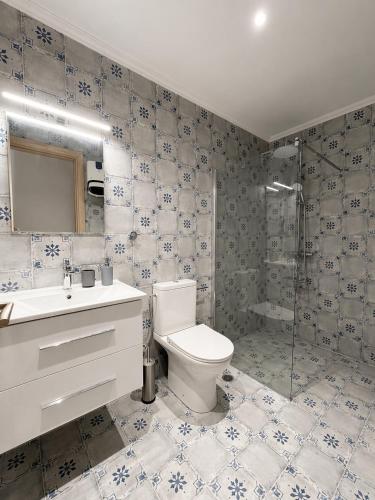 a bathroom with a toilet and a sink and a shower at Casa Plati 1 - Modern Escape with Pool & Garden in Platí