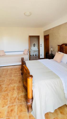 a large bedroom with two beds and a fireplace at B&B La Pitagora in Porto Garibaldi