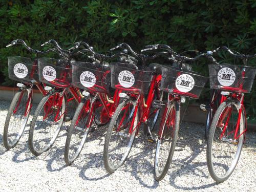 a group of red bikes parked next to each other at Hotel Matilde in Marina di Massa