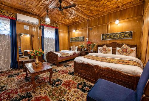 a hotel room with two beds and a couch at The Heritage Group of Houseboats in Srinagar