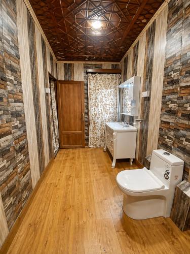 a bathroom with a toilet and a sink at The Heritage Group of Houseboats in Srinagar