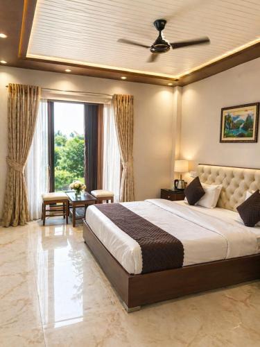 a bedroom with a large bed and a window at Paavan Palace in Ayodhya