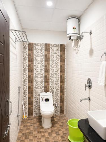 a bathroom with a toilet and a sink at Paavan Palace in Ayodhya