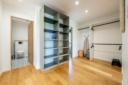 a room with a closet with blue shelves at L'Evasion, Piscine et jacuzzi in Lescherolles