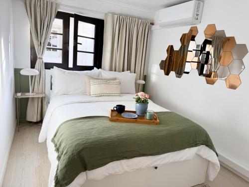 a bedroom with a bed with a tray on it at Heart of Cascais Cozy 2BR Steps from Beach in Cascais