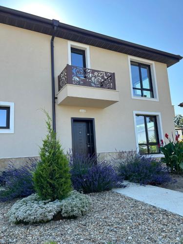 a house with a balcony and purple flowers at Villa Belvedere in Varna City
