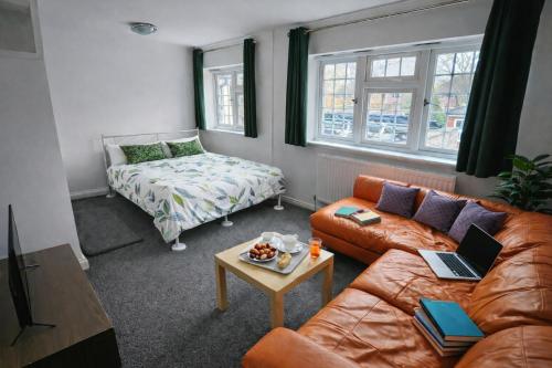 a living room with a couch and a table at Value Stay Comfortable Rooms Windsor Legoland Heathrow in Windsor