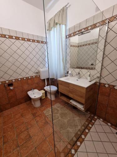a bathroom with a toilet and a sink and a shower at Villa Sunshine in Balestrate