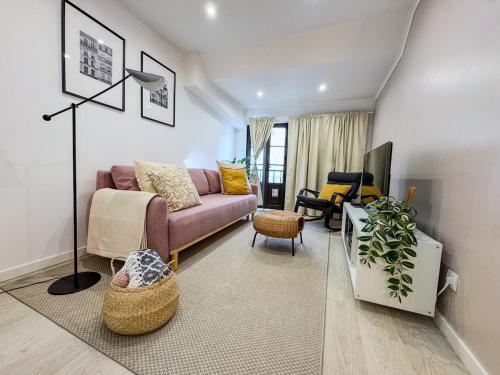 a living room with a couch and a chair at Heart of Cascais Cozy 2BR Steps from Beach in Cascais