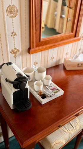 a coffee maker sitting on top of a table at Hotel MERTIN in Chomutov