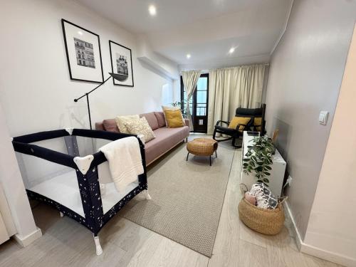 a living room with a couch at Heart of Cascais Cozy 2BR Steps from Beach in Cascais