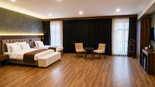 a hotel room with a bed and a table and chairs at Vita Suites Karaköy in Istanbul