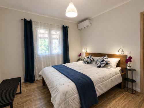a bedroom with a large bed and a window at Casa Plati 2 - Peaceful Garden Stay with Pool in Platí