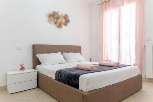 a bedroom with a large bed and a window at Sterlizia Rooms in Gallipoli