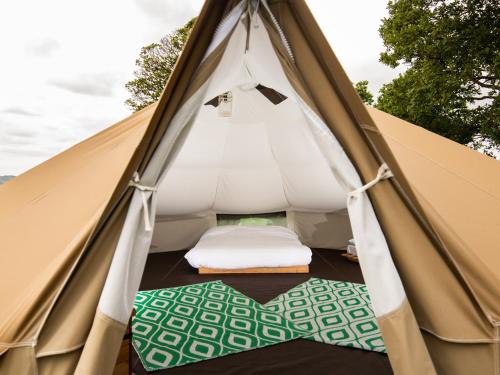 a tent with a bed and mats in it at YHA Windermere in Troutbeck