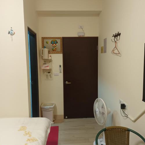 a room with a black door and a room with a fan at Kiutaro 2 in Yuli