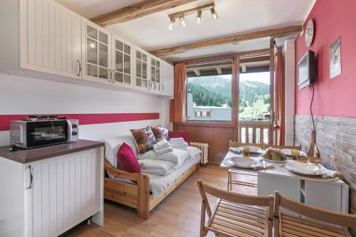 a living room with a couch and a table at Studio Valleverde 26B - Happy Rentals in Sestriere
