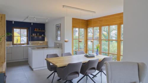 a kitchen with a wooden dining table and chairs at Ferienhaus Mind-Storm in Rimsting