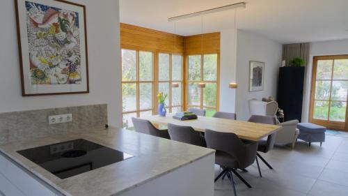 a kitchen and dining room with a table and chairs at Ferienhaus Mind-Storm in Rimsting