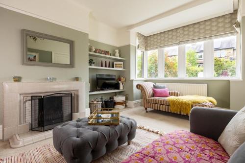 a living room with a fireplace and a couch at The Kingsway in Ilkley