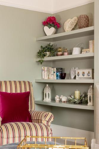 a living room with a couch and shelves at The Kingsway in Ilkley