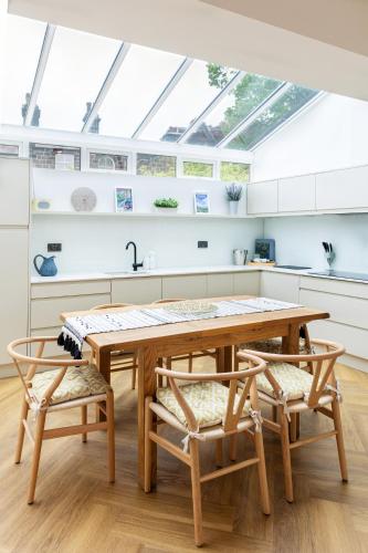 a kitchen with a wooden table and two chairs at The Kingsway in Ilkley
