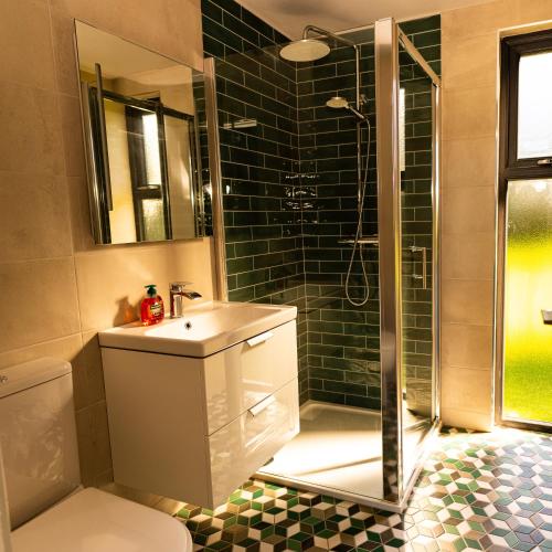 a bathroom with a sink and a shower at Wild Atlantic Camp in Creeslough