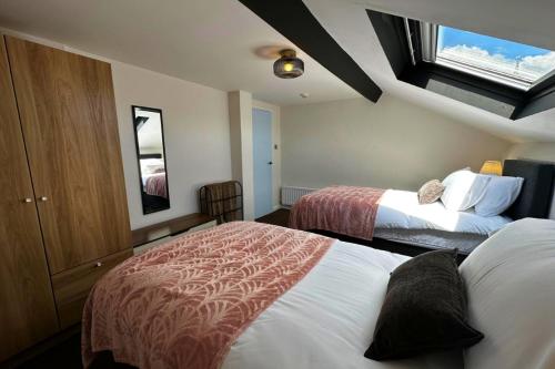 a hotel room with two beds and a window at The Joseph Cosy at Lancaster in Lancaster