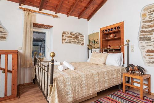 a bedroom with a bed in a room at Mulberry Cottage in Samos