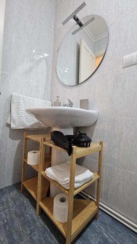 a bathroom with a sink and a mirror at 2 Hermanas in Cudillero