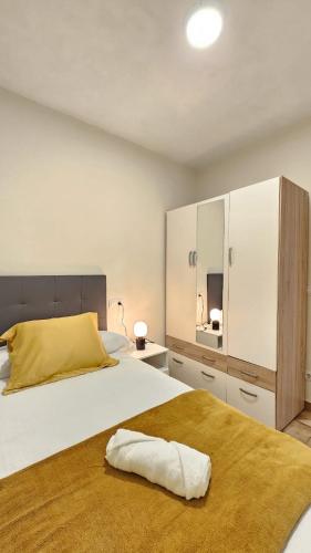 a bedroom with a large bed with a yellow pillow on it at 2 Hermanas in Cudillero