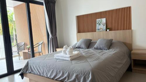 a bedroom with a bed with towels on it at My Home Villa Phangnga in Phangnga