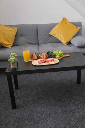 a coffee table with a plate of food on it at Peaceful 1BR Retreat Near Downtown in Manchester