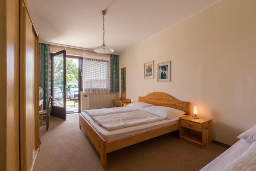 a bedroom with a bed and a lamp on a table at Haus Helene in Mörbisch am See