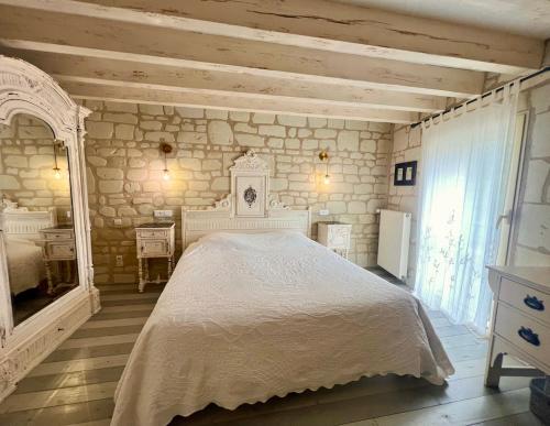 a bedroom with a white bed in a room at La Motelle N 5 in Les Ulmes