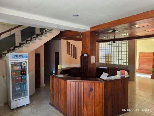 a restaurant with a drink counter and a refrigerator at L'Hotel 5-5 in Mahajanga