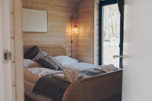 a bed in a room with a window at Resort Wilsumer Berge in Wilsum