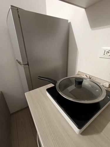 a plate sitting on a counter next to a refrigerator at Arcadia Hosting Piazza XX Settembre in Bologna