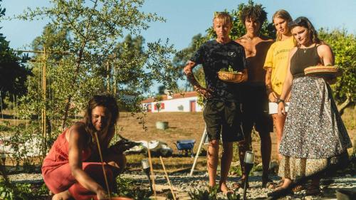 a group of people standing in a garden at Casa no Campo in Porto Covo
