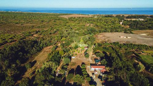 an aerial view of a house on a hill next to the ocean at Casa no Campo in Porto Covo