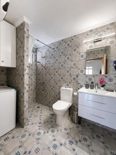 a bathroom with a toilet and a sink at Casa Plati 2 - Peaceful Garden Stay with Pool in Platí