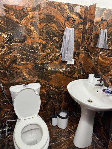 a bathroom with a toilet and a sink at Forum View 2 in Durrës