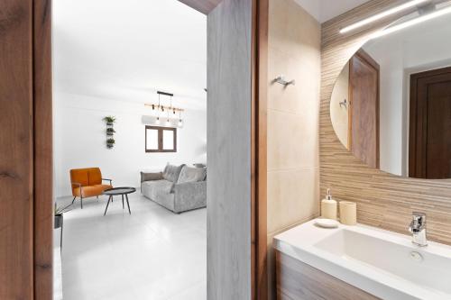a bathroom with a sink and a living room at Lambda Luxury Villa 2 in Syvota
