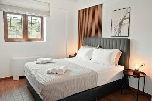 a bedroom with a bed with two towels on it at Lambda Luxury Villa 2 in Syvota