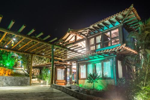 a house with a lit up facade at night at La Pedrera Small Hotel & Spa in Búzios