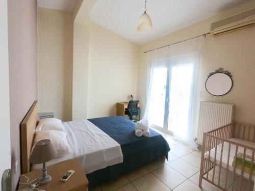 a bedroom with a bed and a large window at Luxury Beachfront Suite in Volos