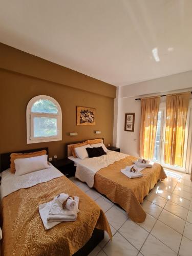 a bedroom with two beds with towels on them at Paradise studios in Nikiti