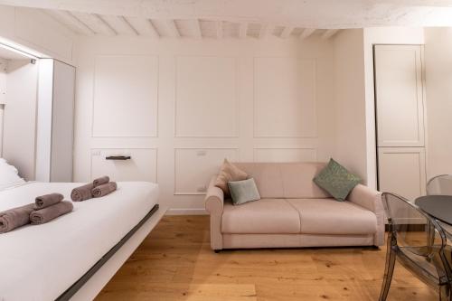 a living room with a couch and a chair at GL Suite Via Baglioni in Perugia