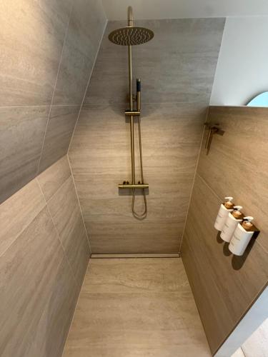 a bathroom with a shower with a light fixture at Breeze Inn B&B in Oegstgeest