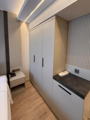 ein Schlafzimmer mit einem großen weißen Schrank mit einer Ablagefläche in der Unterkunft Kayalar Hotel in Antalya
